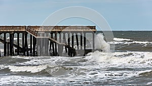 Big stormy waves crash on the pier