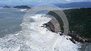 Big stormy waves in ocean. Aerial view of coastline with mountain and rocks