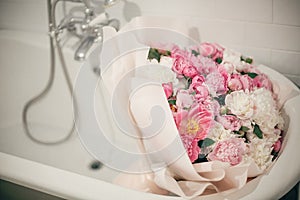 Big stylish peony bouquet in bathtub in modern bathroom. Happy mothers day. Valentines day. Aroma scent concept. International