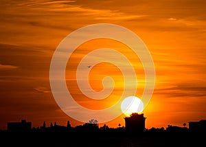 Big sun at sunset orange city line silhouette