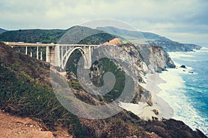 Big Sur, California. Historic Bixby Bridge, rocky coastline, ocean view, and cloudy sky