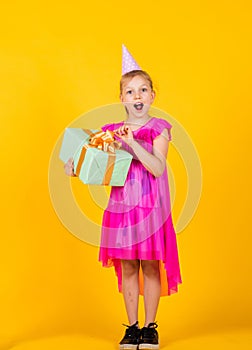 big surprise. kid holding gift package. holiday preparation and celebration childhood happiness. cute child go shopping