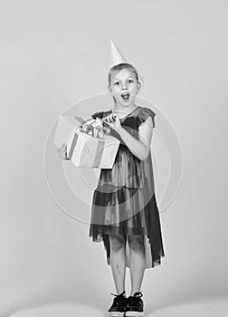 big surprise. kid holding gift package. holiday preparation and celebration childhood happiness. cute child go shopping