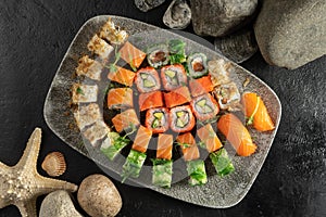Big sushi set. Sushi rolls and nigiri with salmon, avocado, tobiko caviar, tuna flakes, chuka salad