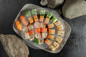 Big sushi set. Sushi rolls and nigiri with salmon, avocado, tobiko caviar, tuna flakes, chuka salad.