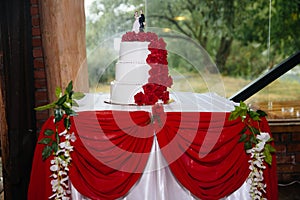 Big sweet multilevel wedding cake decorated with flowers. Concept of candy bar on party