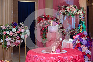 Big sweet multilevel wedding cake decorated with flowers. Concept of candy bar on party