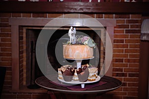 Big sweet multilevel wedding cake decorated with flowers. Concept of candy bar on party