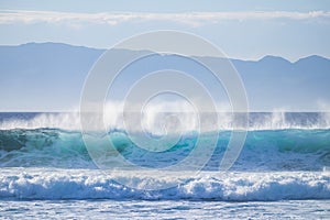 Big swell wave with white foam high energy impact perfect for surf and body board activity - danger with the ocean water -