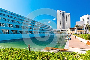 Big swimming pool with deck of a luxury hotel against blue sky