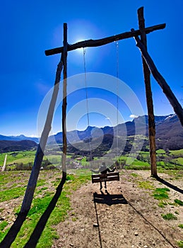 A big swing in pico Caleo, viewpoint over Lario village, MontaÃ±a de RiaÃ±o y Mampodre Regional Park, Leon province, Spain photo