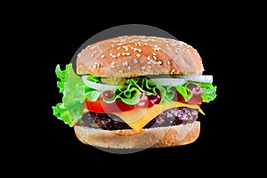 Big tasty hamburger or cheeseburger on black background with grilled meat, cheese, tomato, bacon, onion. Burger