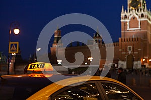 The big taxi sign on the background of night city. Moscow taxi.