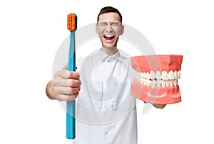 Big teeth dummy and dentist doctor with tooth brush screaming yelling