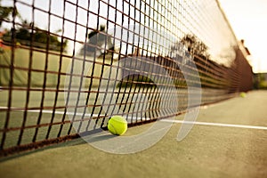 Big tennis ball at the net, nobody, outdoor court