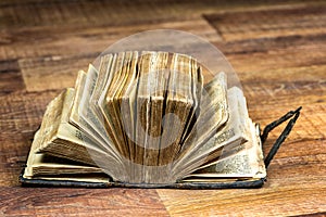 Big thick open book on brown background