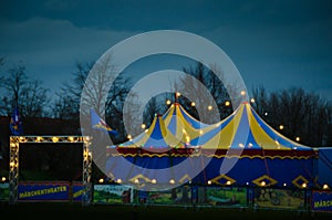A big top of a circus lightened in the evening