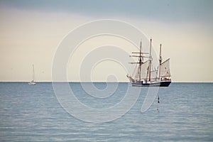 Big tourist ship and small yach on water landscape