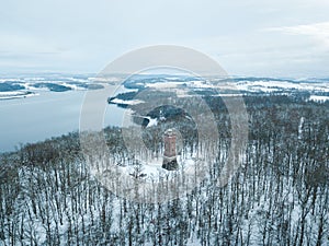 Big tower in the middle of a white forest.