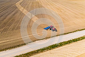 Big tractor ploughing dry soil in rural area. Precipitation problem