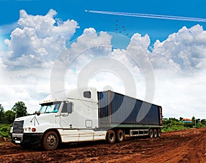 The big transport truck with the mud country road, the beautiful sky cloud, storm, thunderstorm sky clouds.