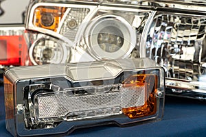 A big truck on the road. Modern new halogen headlights on a truck. Truck headlights. Square red headlight and reflector on the