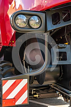 A big truck on the road. Modern new halogen headlights on a truck. Truck headlights. Square red headlight and reflector on the