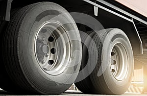 A big truck wheels tires of trailer truck. Road freight. Logistics and transportation.