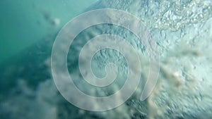 big tube wave sweeps over the camera on a sunny summer