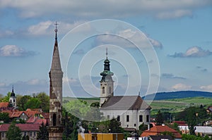 Big Turkish Minaret and church bell tower in Eger cityscape