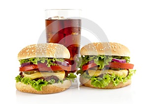 Big two cheeseburgers with glass of cola isolated on white