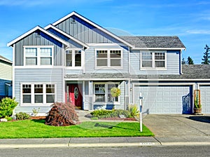 Big two story house. View of entance porch and garage