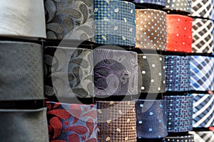 Big variety of different color neckties in a men clothing store