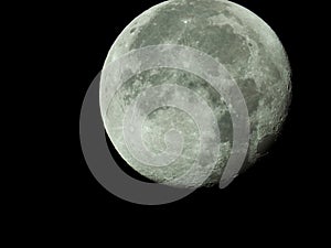 Big waning moon with its moon craters in the black night sky