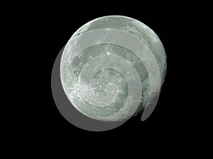 Big waning moon with its moon craters in the black night sky