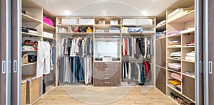 Big wardrobe with different clothes for dressing room