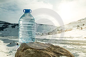 Big Water bottle with snowy mountain peak background.