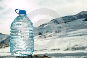 Big Water bottle with snowy mountain peak background.