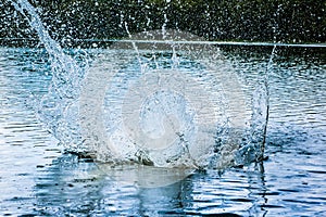 A big water splash in the blue water