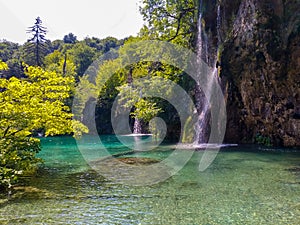 Big waterfall in forest with beutiful lake