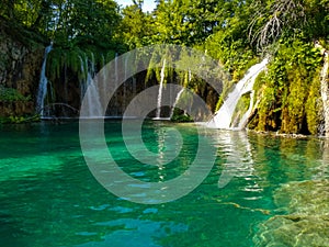 Big waterfall in forest with beutiful lake