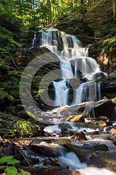 Big waterfall in green forest