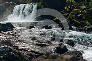 Big waterfall and rushing river in the forest