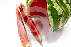 Big watermelon and slice isolated on white background