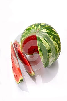 Big watermelon and slice isolated on white background