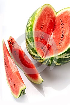 Big watermelon and slice isolated on white background