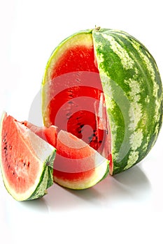 Big watermelon and slice isolated on white