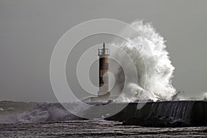 Big wave against lighthouse