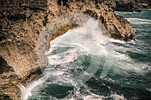 Big wave hitting rocks. Nature find its way