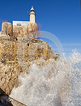 Big wave at lighthouse